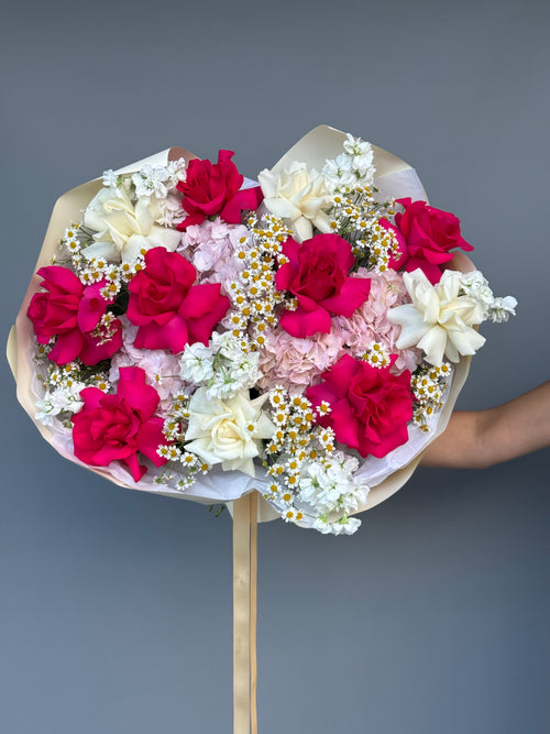 Handcrafted luxury bouquet with pink roses and seasonal blooms