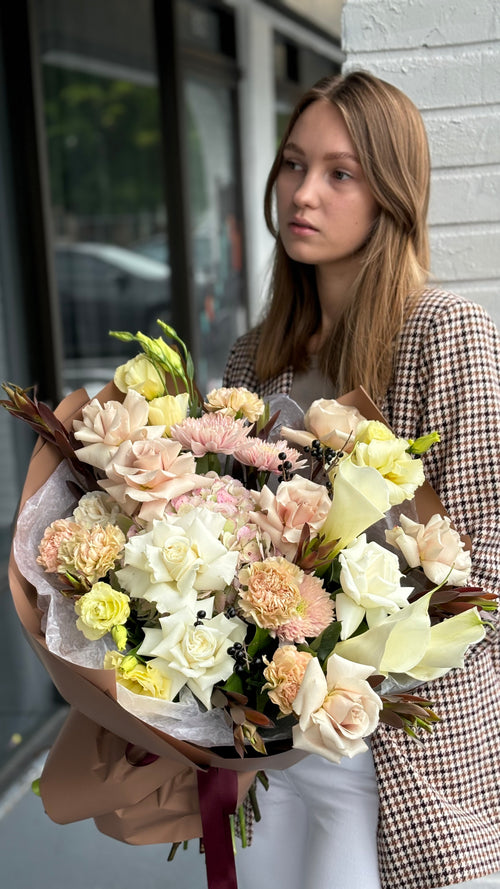 Woman holding a bouquet of flowers against a blurred background