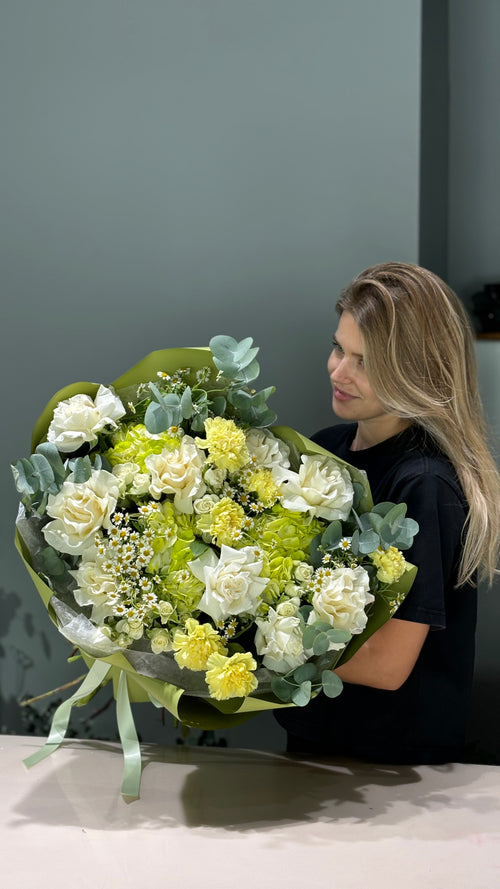 Bouquet of green and creme flowers with leaves