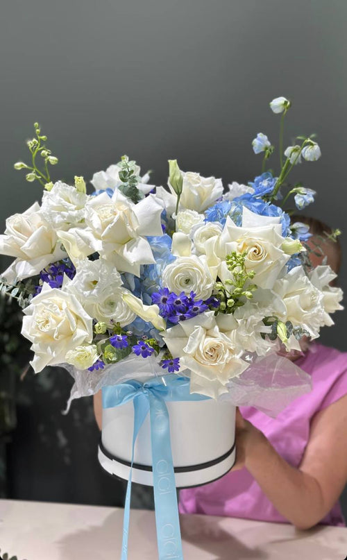 Beautiful flowers with white, purple and blue color in a basket