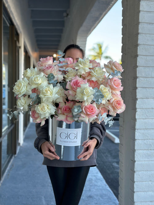 Light peach and crème colored flowers in a basket