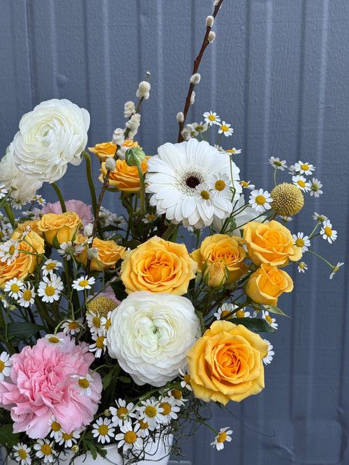 Bright yellow, white and pink flowers in a pot