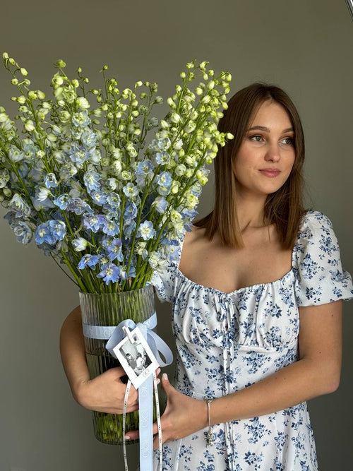 Bouquet of blue flowers carried by a girl