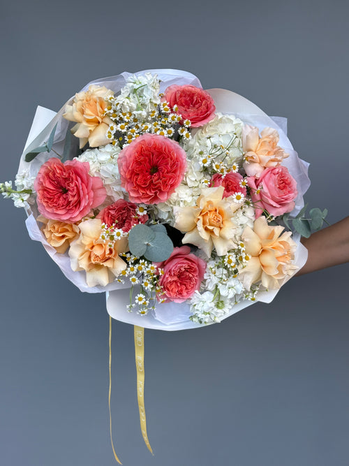 Premium bouquet featuring coral garden roses, cream roses and white hydrangeas