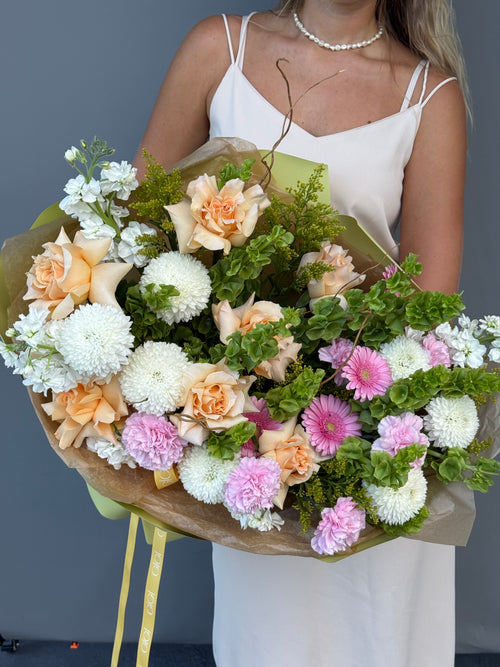 Luxury bouquet featuring premium peach roses, moluccella, gerbera daisies, and white chrysanthemums