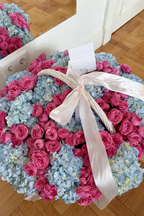 Basket of blue hydrangeas and pink garden roses