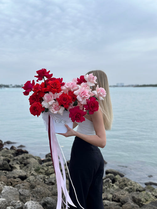 Red and pink colored flowers basket